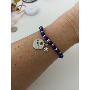 blue and gold bead bracelet with fancy Star charms